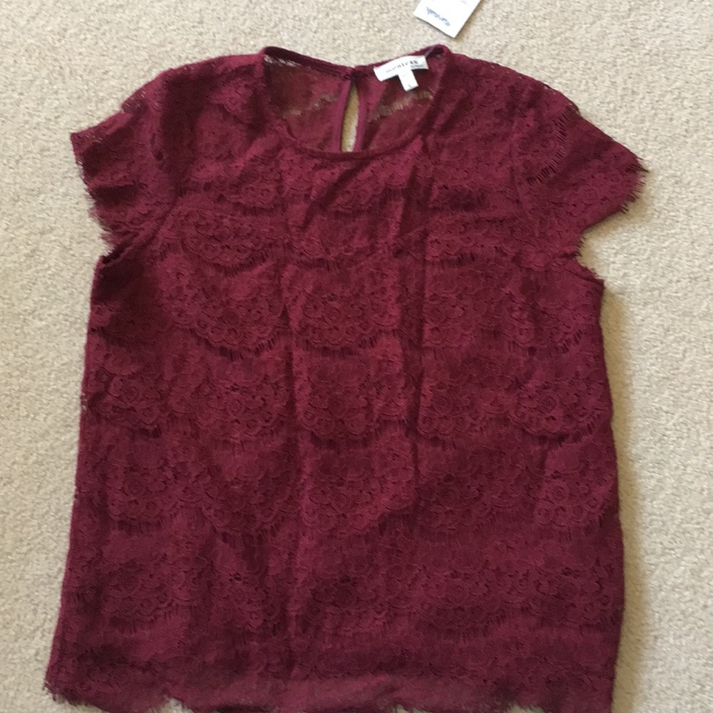 Women’s burgundy lace blouse.
